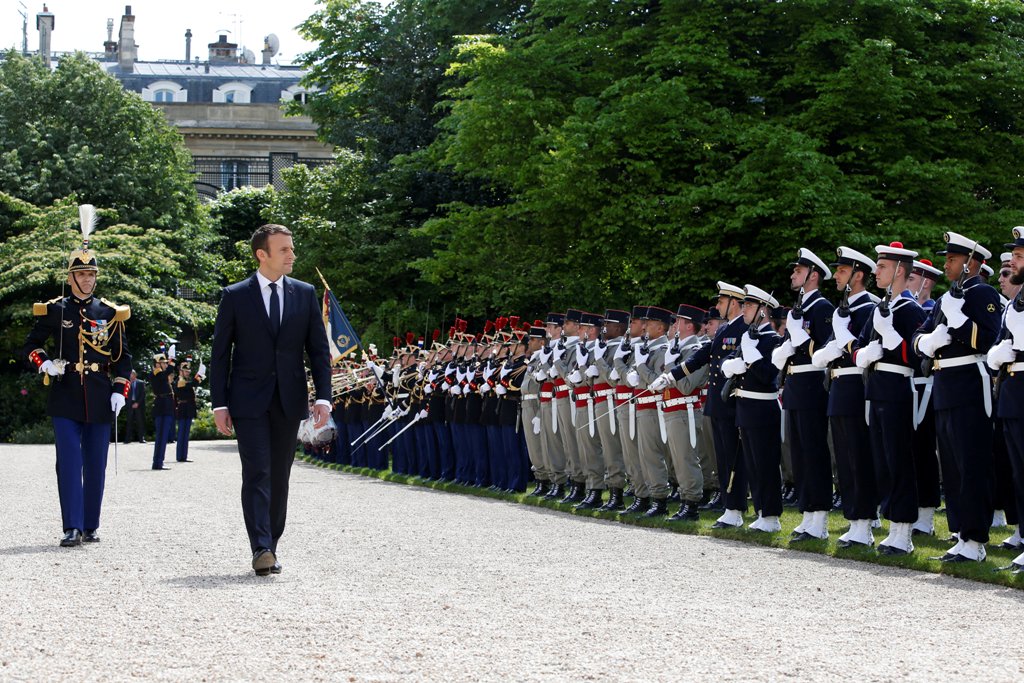 French President Emmanuel Macron reviews troops as he attends a flag ceremony in the garden of the Elysee Palace after his inauguration in Paris, France, May 14, 2017. REUTERS/Gonzalo Fuentes.