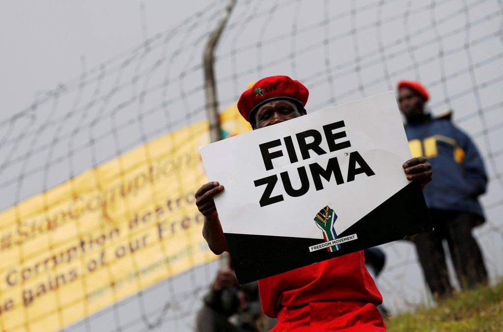 Supporters of various opposition parties hold placards calling for the removal of President Jacob Zuma outside the Constitutional Court in Johannesburg, South Africa, May 15, 2017. REUTERS/Mike Hutchings