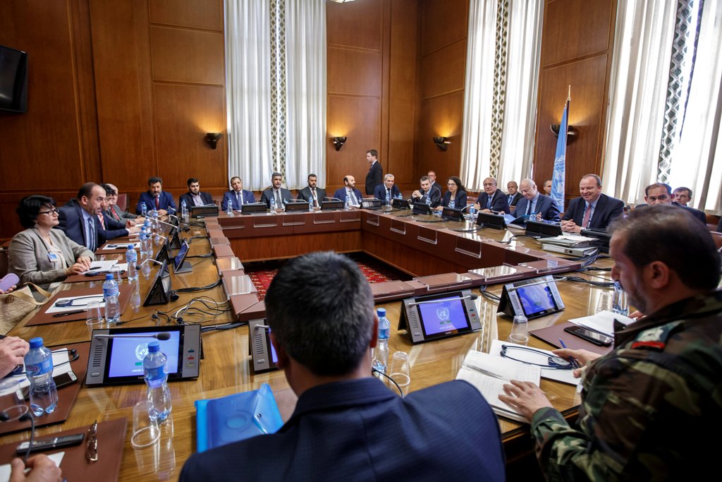 Syria's main opposition High Negotiations Committee (HNC) leader Naser al-Hariri and UN Special Envoy of the Secretary-General for Syria Staffan de Mistura attend a round of negotiation, during the Intra Syria talks, at the European headquarters of the Un