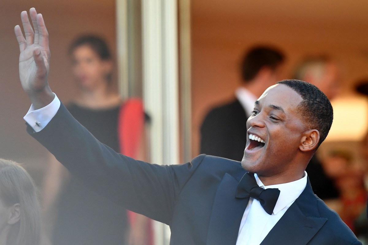 US actor and member of the Feature Film jury Will Smith waves as he arrives on May 17, 2017 for the screening of the film 'Ismael's Ghosts' (Les Fantomes d'Ismael) during the opening ceremony of the 70th edition of the Cannes Film Festival in Cannes, sout
