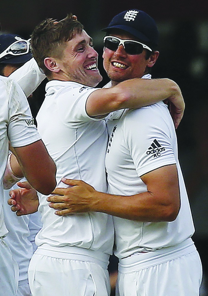 England’s Chris Woakes (left) celebrates with team-mate Alastair Cook during the third day of their first Test at Lord’s in London in this 2015 file picture.