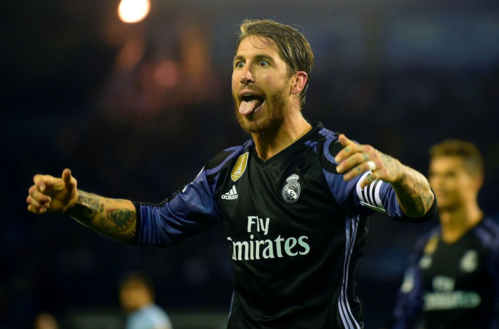 Real Madrid's defender Sergio Ramos celebrates their third goal sticking out his tongue at Celta's supporters during the Spanish league football match RC Celta de Vigo vs Real Madrid CF at the Balaidos stadium in Vigo on May 17, 2017. / AFP / MIGUEL RIOPA