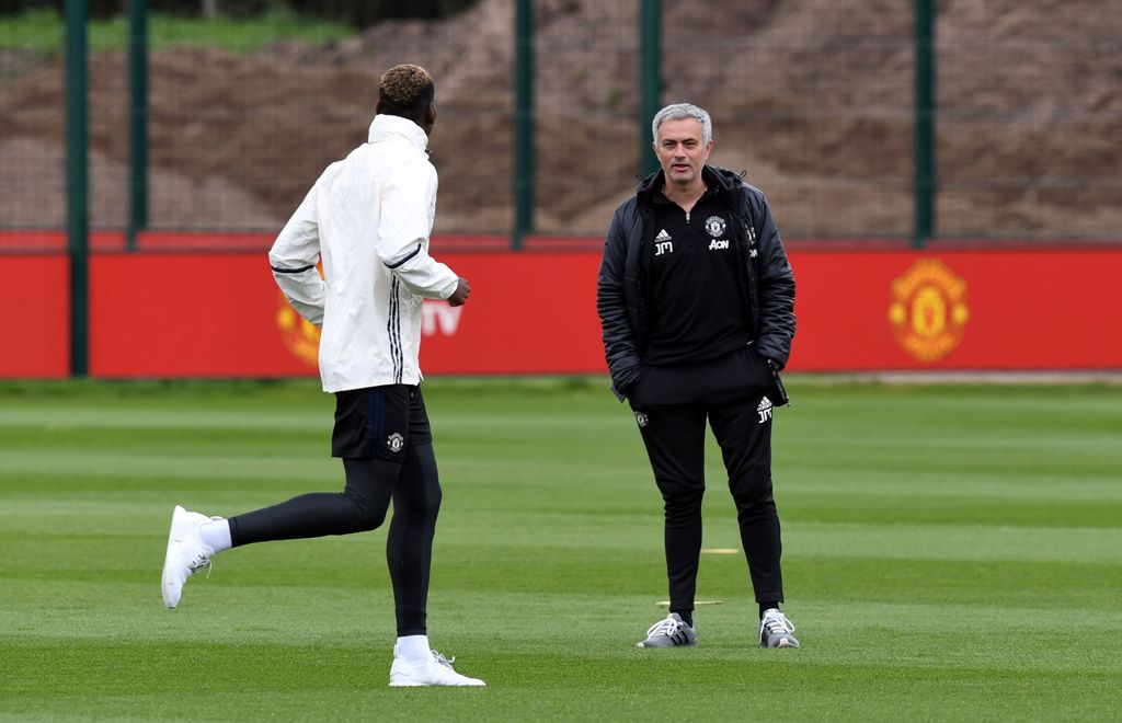 Manchester United's Portuguese manager Jose Mourinho (R) chats to Manchester United's French midfielder Paul Pogba during a team training session as part of a media open day at the club's training complex near Carrington, west of Manchester in north west 