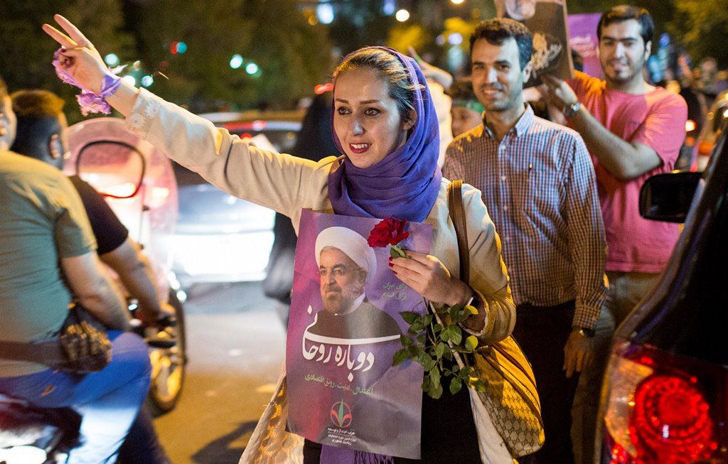 A woman holds a poster of Iranian President Hassan Rouhani during a campaign rally in Tehran, Iran, May 17, 2017. Picture taken May 17, 2017. TIMA via REUTERS