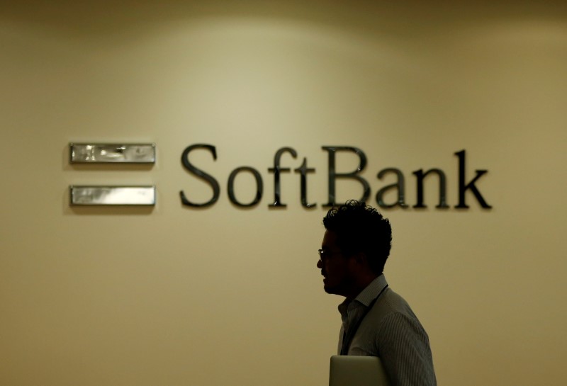 Man walks past the logo of SoftBank Group Corp at the company's headquarters in Tokyo (Reuters)