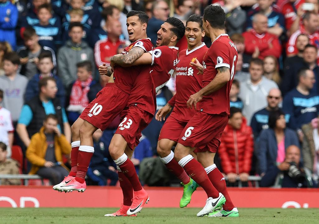 Liverpool's Brazilian midfielder Philippe Coutinho (L) celebrates scoring his team's second goal during the English Premier League football match between Liverpool and Middlesbrough at Anfield in Liverpool, north west England on May 21, 2017.  AFP / Paul 