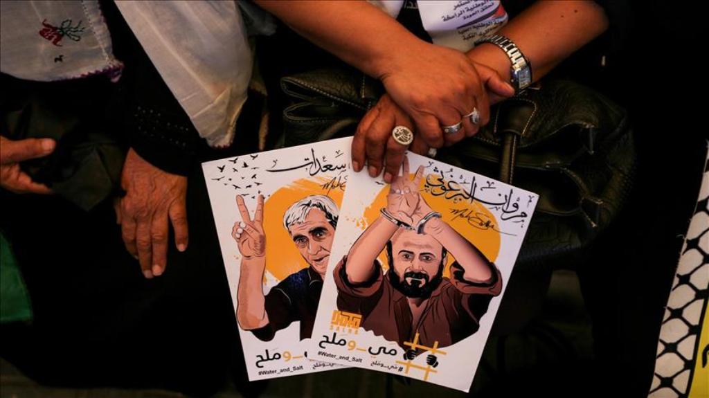 A woman holds posters of Palestinian prisoners who are held in Israeli jails, during a demonstration in support of the Palestinian prisoners, outside the International Committee of the Red Cross (ICRC) in Gaza City, Gaza on May 22, 2017. ( Mustafa Hassona