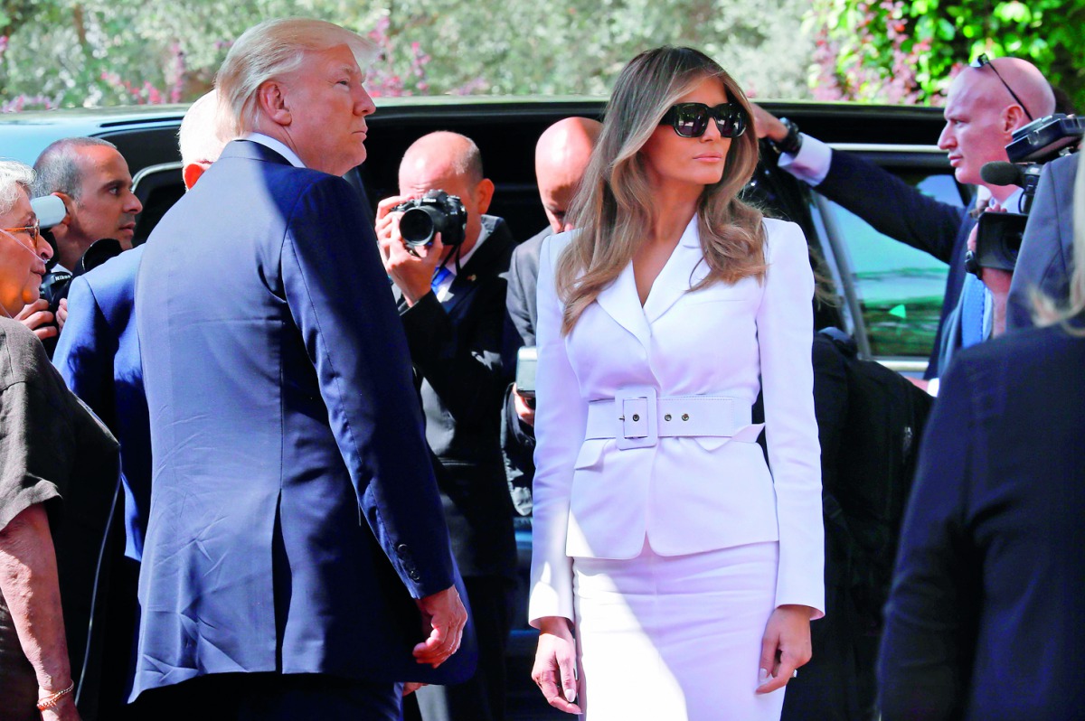 US President Donald Trump and US First Lady Melania Trump arrive at the Israeli President's Residence in Jerusalem, yesterday. Melania Trump (seated right) talk to children during a visit to the Hadassah Ein Kerem hospital in Jerusalem, yesterday.