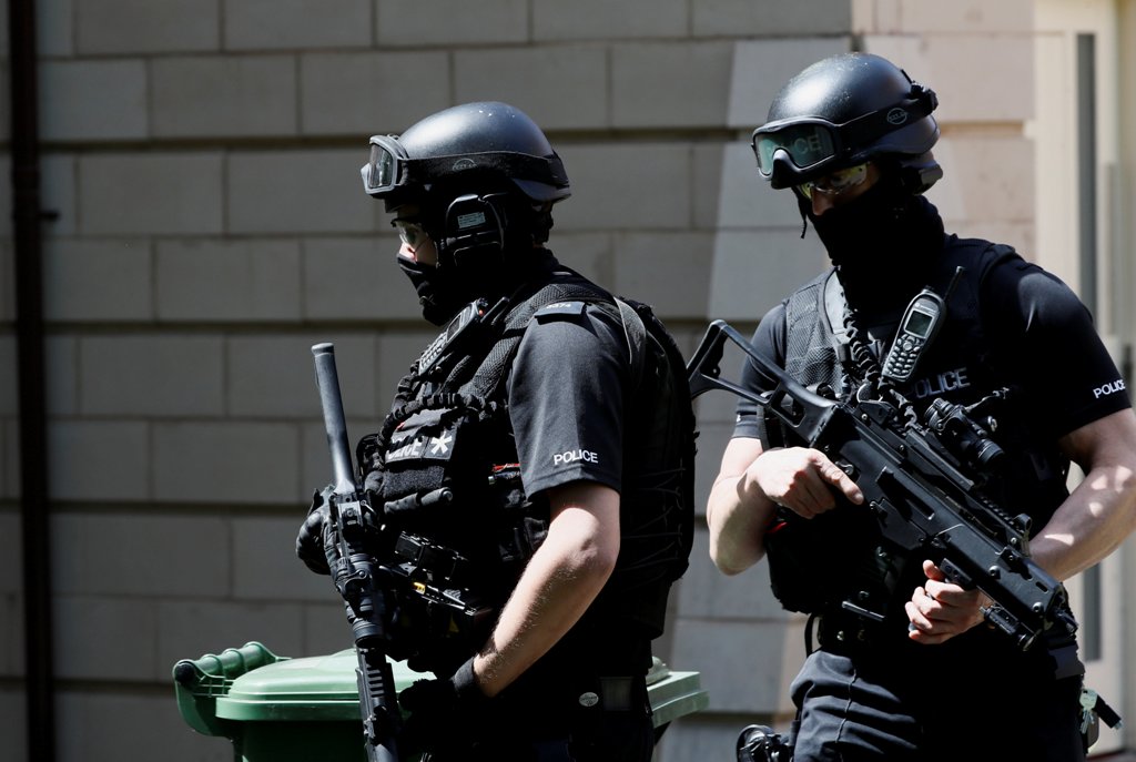 Armed police officers stand outside a residential property near to where a man was arrested in the Chorlton area of Manchester, Britain May 23, 2017. REUTERS/Stefan Wermuth
