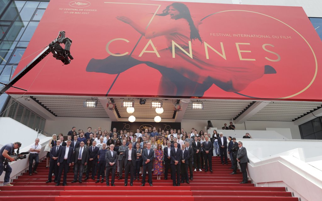 Cannes Film Festival general delegate Thierry Fremaux, Cannes Film festival president Pierre Lescure, actress Isabelle Huppert and staff members observe a minute of silence on the red carpet. REUTERS/Eric Gaillard

