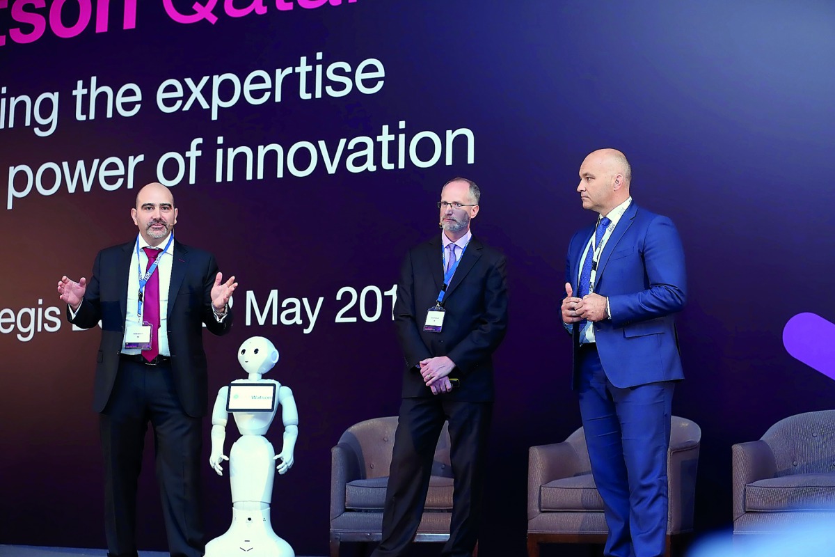 Ooredoo and IBM officials on the stage.