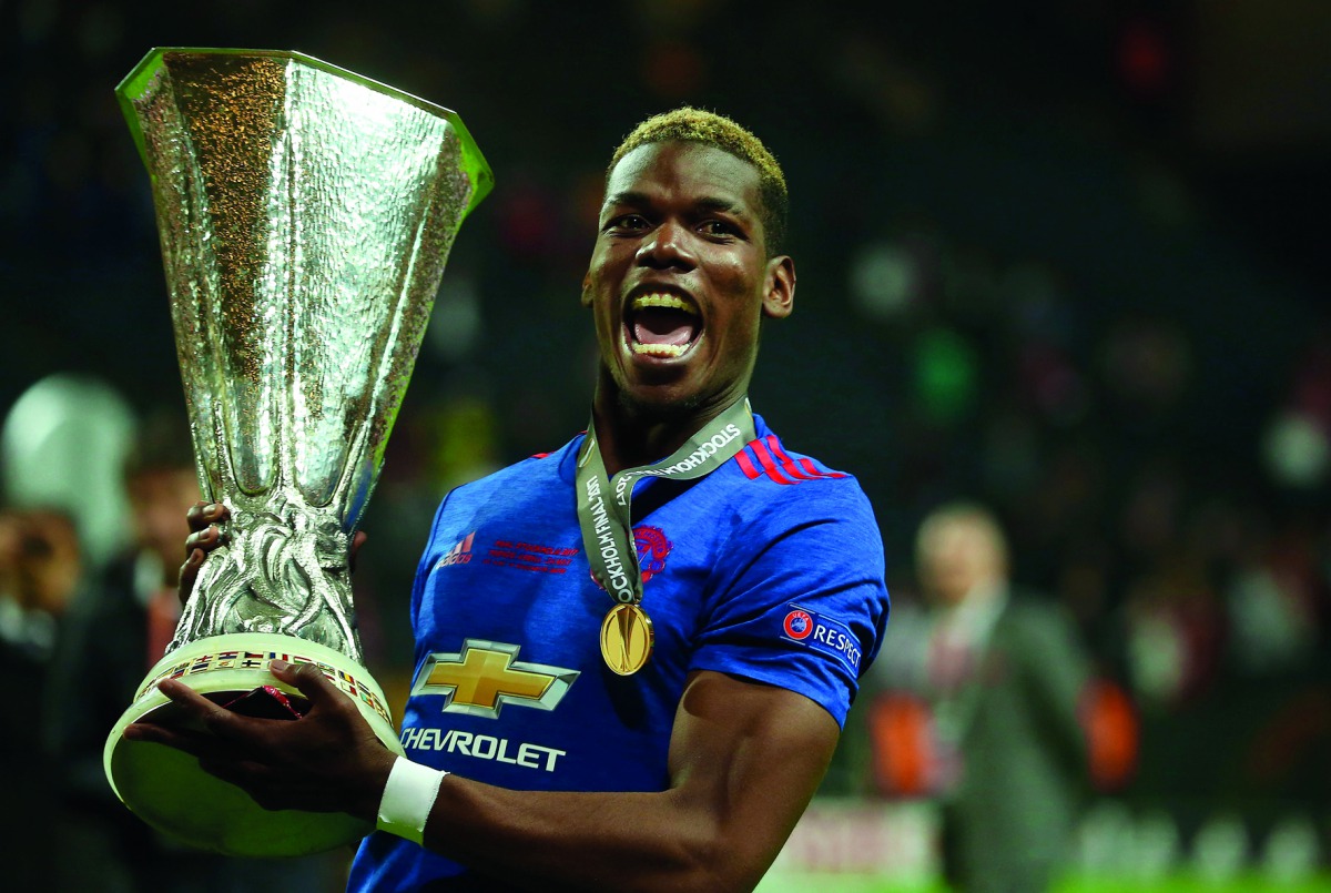 Manchester United's French midfielder Paul Pogba celebrates with the trophy after winning the UEFA Europa League final on Wednesday.