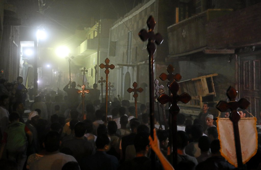 Mourners carry crosses and march after the funeral of Coptic Christians who were killed on Friday in Minya, Egypt, May 26, 2017. REUTERS/Mohamed Abd El Ghany
