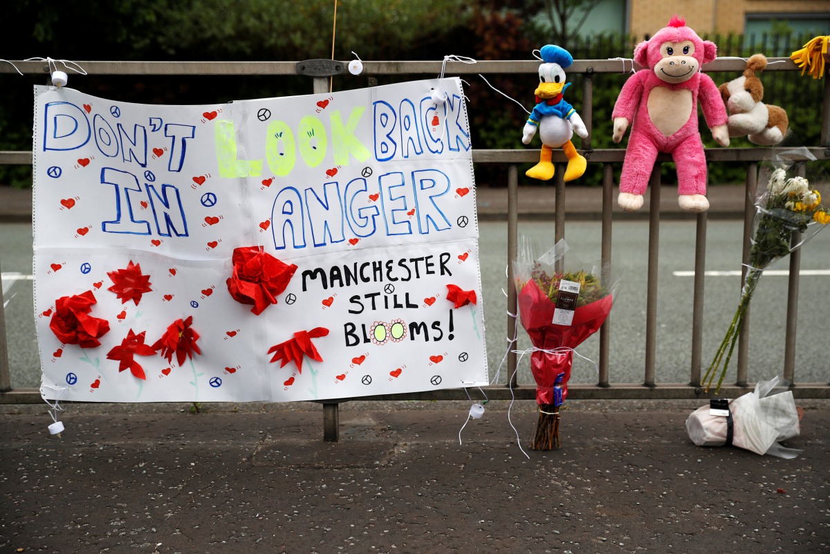 A banner, soft toys and flowers are displayed in Manchester, Britain, May 27, 2017. REUTERS/Phil Noble
