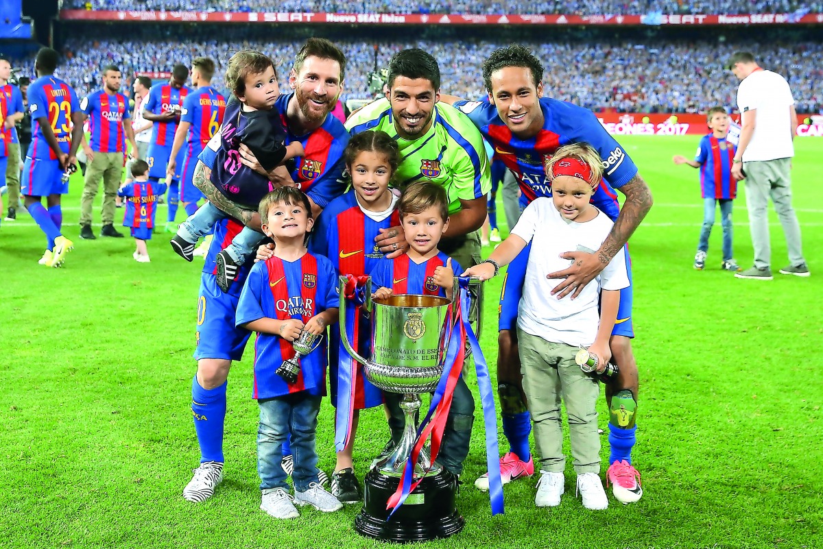 Barcelona’s Lionel Messi, Luis Suarez and Neymar celebrate with the trophy at the end of the Spanish Copa del Rey (King's Cup) final match against Deportivo Alaves at the Vicente Calderon Stadium in Madrid on Saturday.