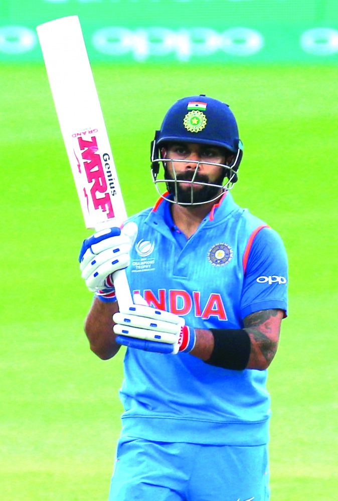 India's captain Virat Kohli celebrates his half century during the ICC Champions Trophy warm-up match against New Zealand at the Oval in London, yesterday.