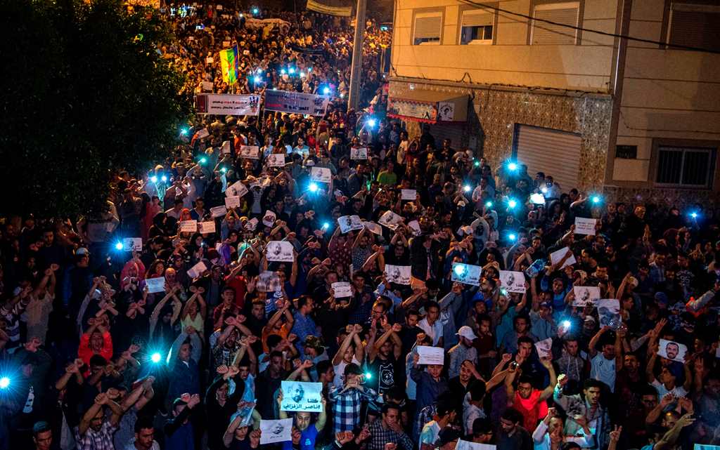 Demonstrators hold pictures of Nasser Zafzafi, leader of the Rif region's protest movement, during a demonstration against corruption, repression and unemployment in the northern city of al-Hoceima on May 30, 2017.  AFP / FADEL SENNA
