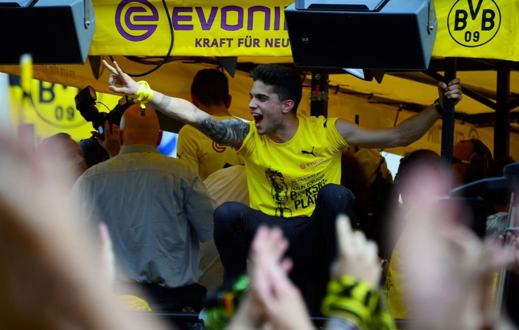 Dortmund's Spanish defender Marc Bartra gestures during celebrations after winning the German Cup final (DFB Pokalfinale) in Dortmund, western Germany, on May 28, 2017. / AFP / Sascha Schuermann
