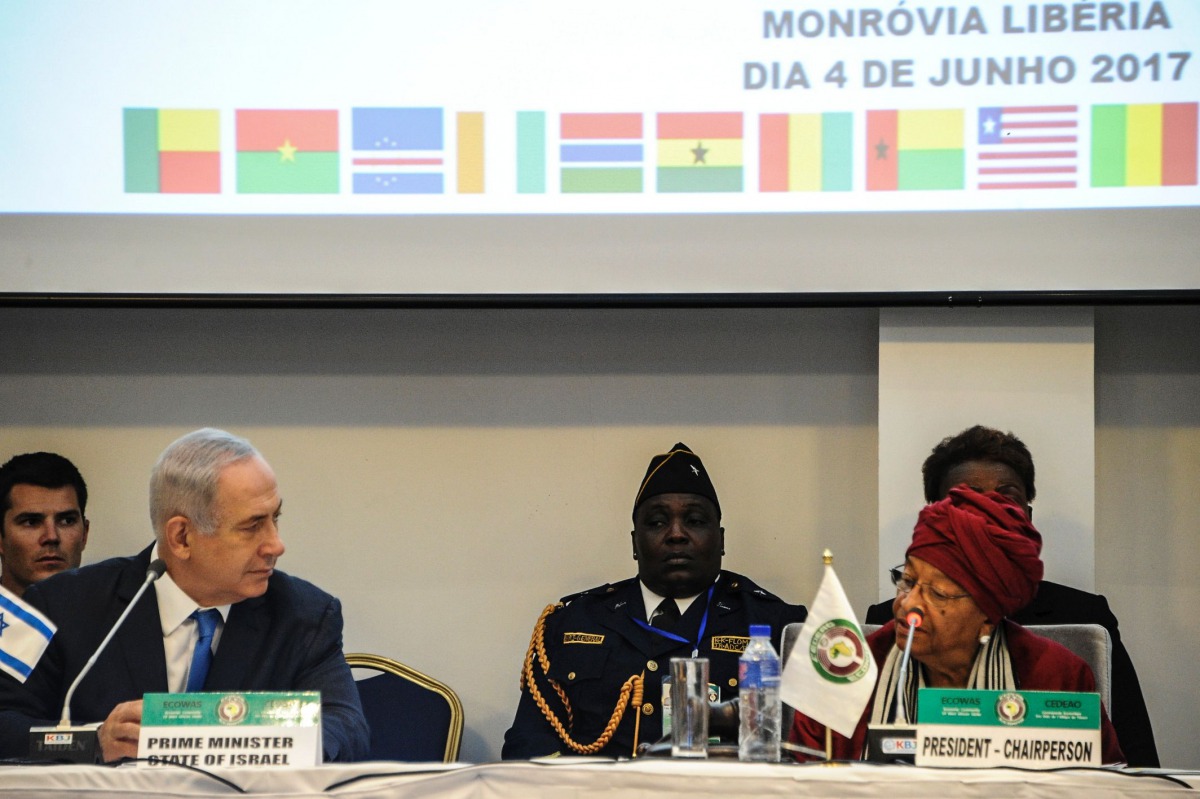 Israel's Prime Minister Benjamin Netanyahu (2-L) looks on as Liberia's President and ECOWAS (Economic Community of West African States) Chairperson Ellen Johnson Sirleaf (R) speaks during the ECOWAS summit on June 4, 2017 in Monrovia.  AFP / Zoom Dosso