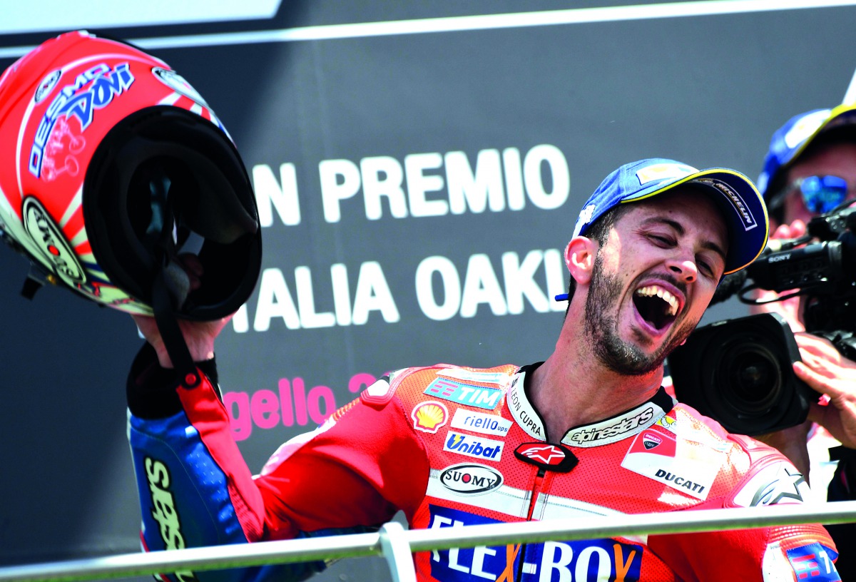 Ducati's rider Italian Andrea Dovizioso celebrates on the podium after winning the Moto GP Grand Prix at the Mugello race track, yesterday.