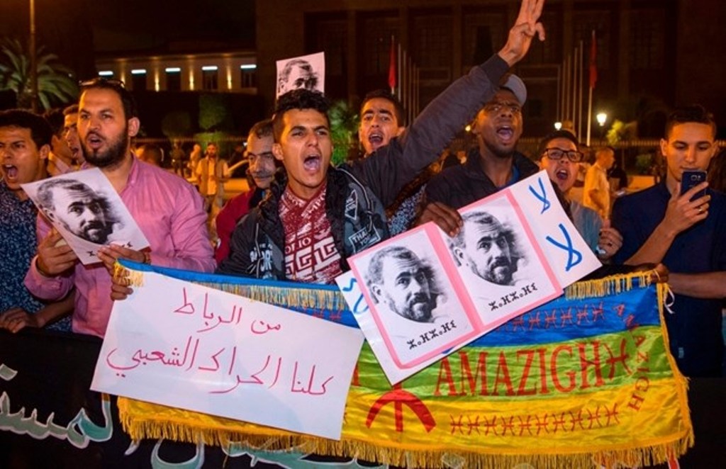 Protesters hold portraits of grassroots leader Nasser Zefzafi during a demonstration June 4, 2017 in Rabat in solidarity with Morocco's neglected Rif region. Nasser Zefzafi, was arrested May 29, 2017 after three days on the run. / AFP / STR.