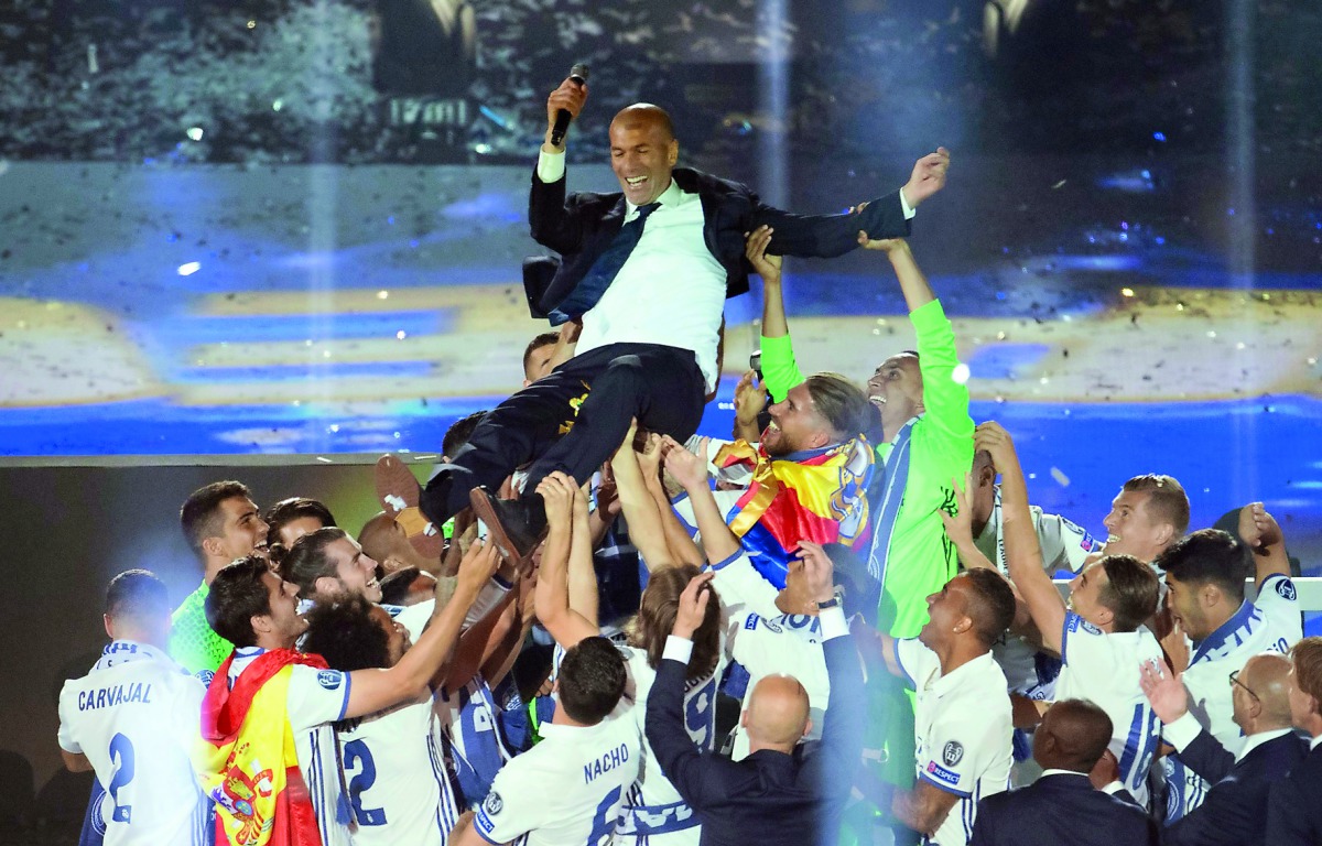 Real Madrid's French coach Zinedine Zidane is tossed by players as they celebrate the team's win, at the Santiago Bernabeu Stadium in Madrid on Sunday. 