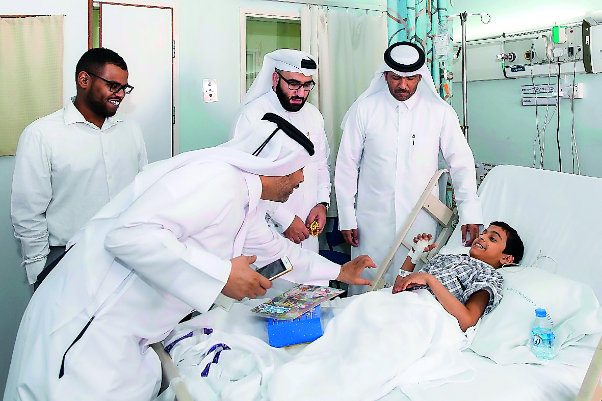 Ooredoo volunteers meet a patient at Hamad General Hospital’s Children Ward.