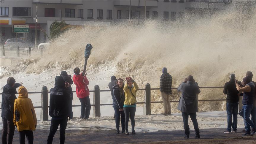 CAPE TOWN, SOUTH AFRICA - JUNE 7: People stand over the bridge as the huge waves hit coastline during the heavy storm in Cape Town, South Africa on June 7, 2017. ( Ashraf Hendricks - Anadolu Agency ).