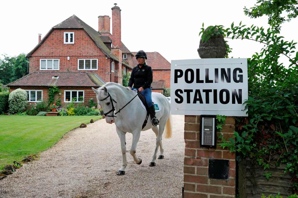 Sophie Allison, riding her horse Splash, rides out of the driveway of a private residence, set up as a Polling Station, near Reading, west of London, on June 8, 2017, as Britain holds a general election.   AFP / Adrian DENNIS
