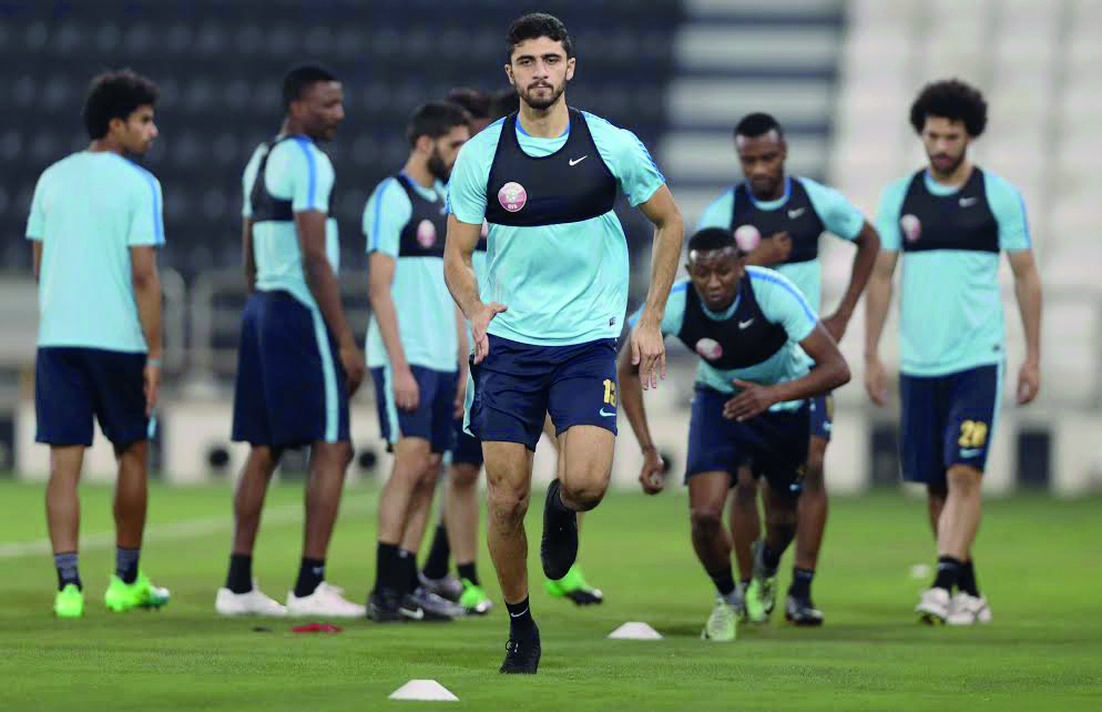 Qatar's Ahmed Al Sayed (centre) along with his team-mates during a training session ahead of the World Cup Qualifying match against South Korea. The match will be played in Doha today. 
