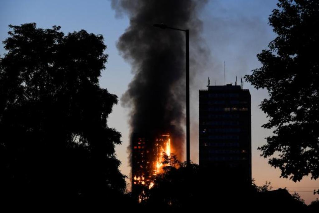 Flames and smoke billow as firefighters deal with a serious fire in a tower block at Latimer Road in West London, Britain June 14, 2017. REUTERS/Toby Melville.