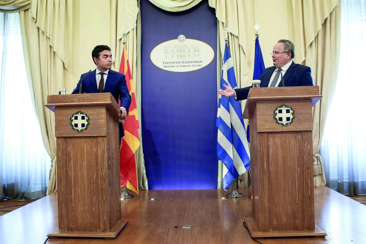 Macedonian Foreign Minister Nikola Dimitrov (left) with his Greek counterpart Nikos Kotzias after their meeting in Athens, yesterday.