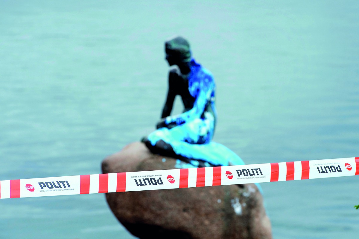 Police tape is seen in front of a paint-covered Little Mermaid statue in Copenhagen, yesterday.