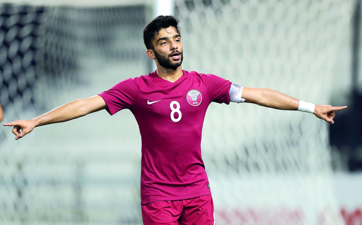 A Qatari player celebrates after scoring a goal.