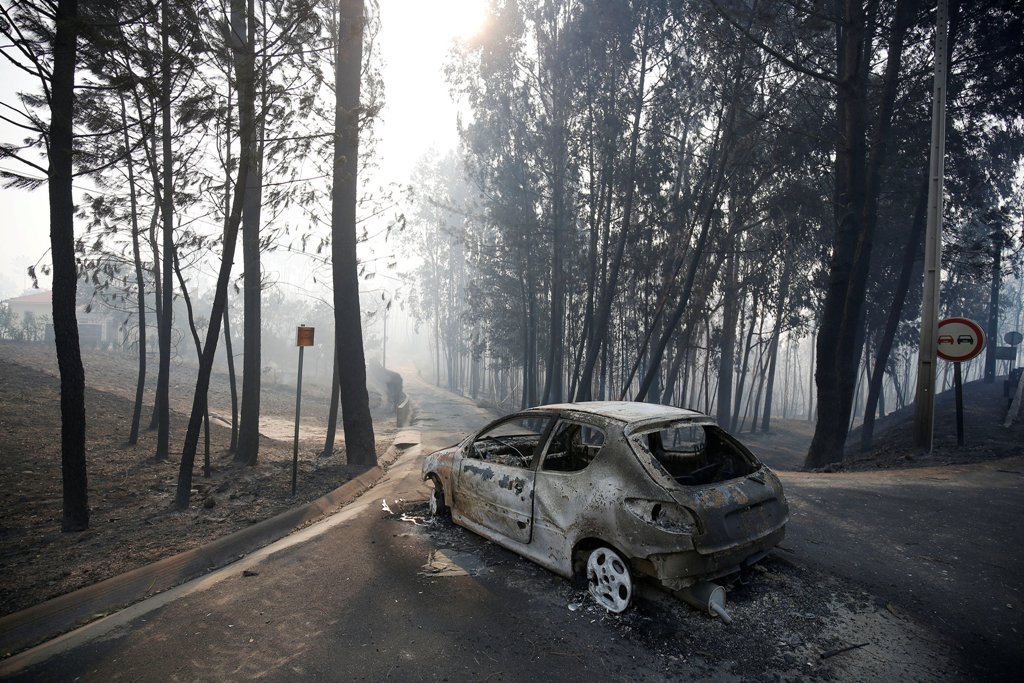 A burned car is seen in the aftermath of a forest fire near Pedrogao Grande, in central Portugal, June 18, 2017. REUTERS/Rafael Marchante