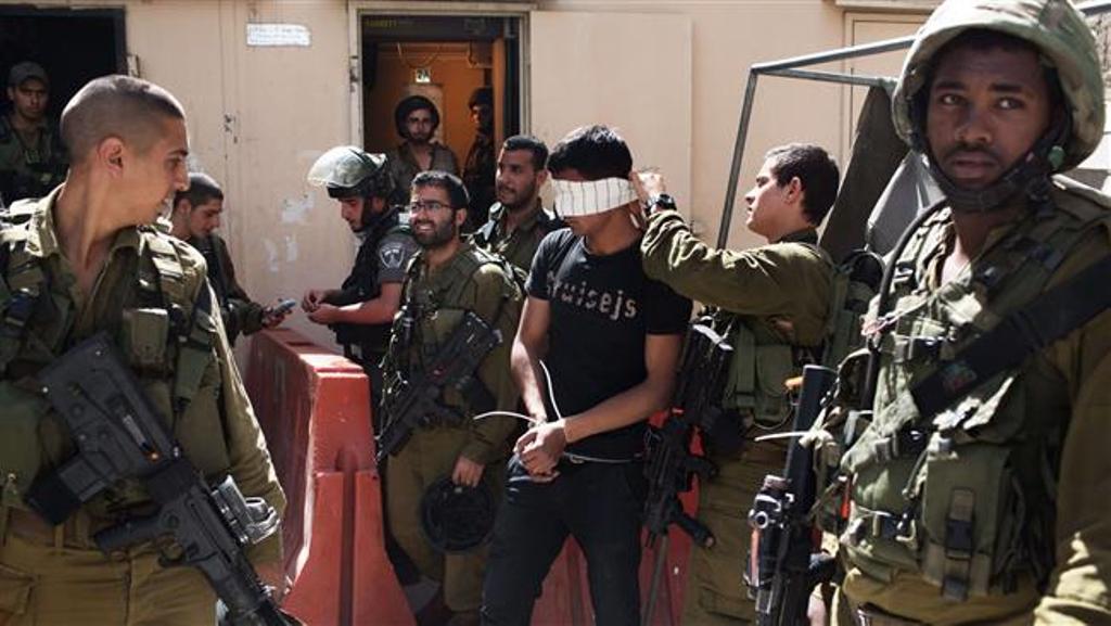 This file photo shows a Palestinian man arrested by Israeli soldiers in the occupied West Bank city of al-Khalil (Hebron). © AFP.