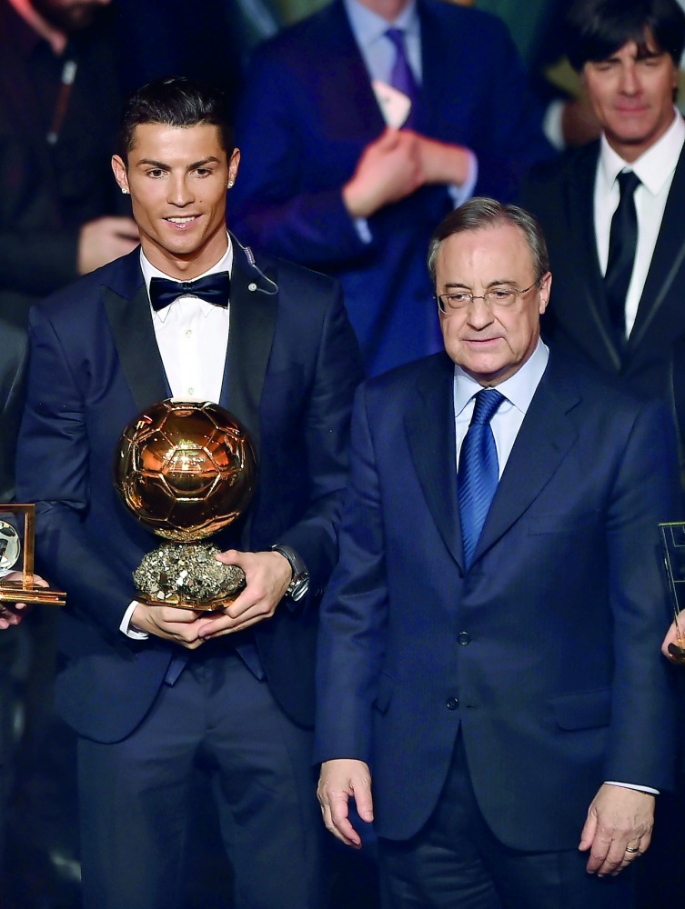 Real Madrid's forward Cristiano Ronaldo (left), winner of the 2014 FIFA Ballon d'Or award for player of the year and Real Madrid's President Florentino Perez posing on stage at the end of the 2014 FIFA Ballon d'Or award ceremony at the Kongresshaus in Zur