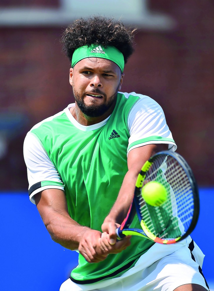 France's Jo-Wilfried Tsonga returns against France's Adrian Mannarino in their first round match at Queen's Club Championships in London, yesterday. 