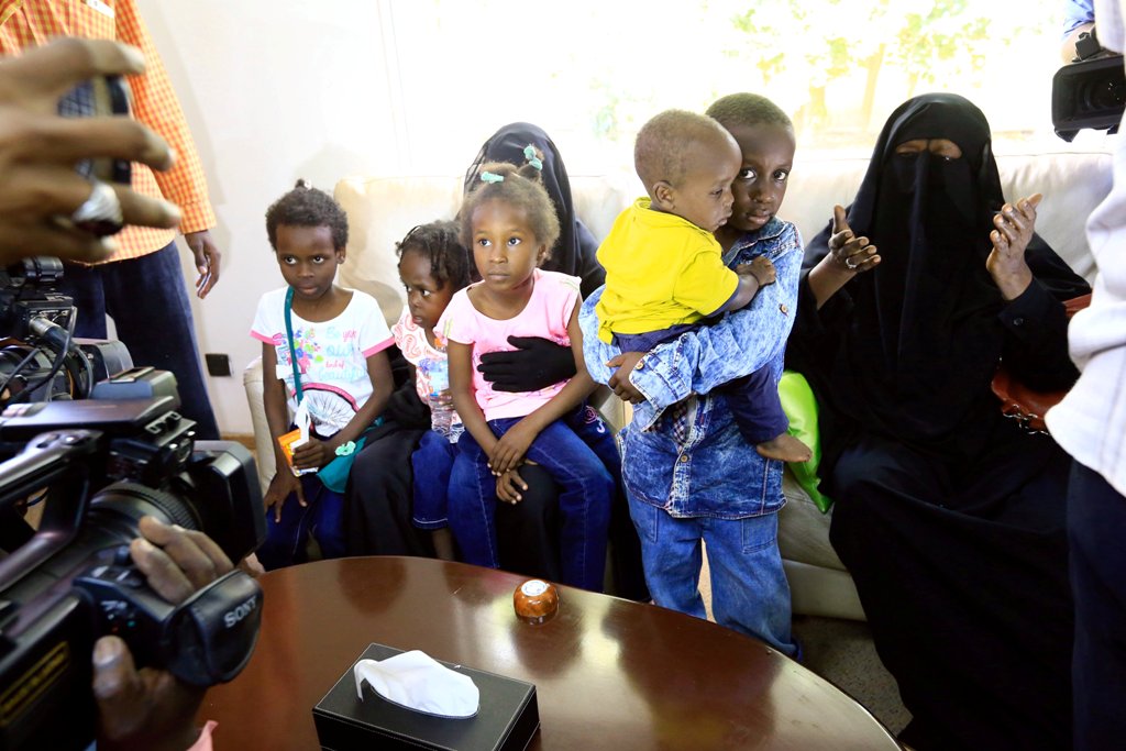 Relatives hug children of Sudanese Islamic State members who operated in Libya, as they arrive at Khartoum airport, Sudan June 20,2017 . REUTERS/Mohamed Nureldin Abdallah.
