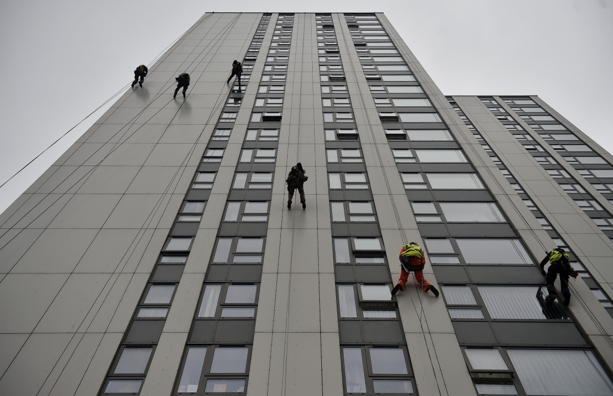 Specialists abseil down the side of Bray Tower to check the cladding, on the Chalcots Estate in north London, Britain, June 27, 2017. Reuters/Hannah McKay