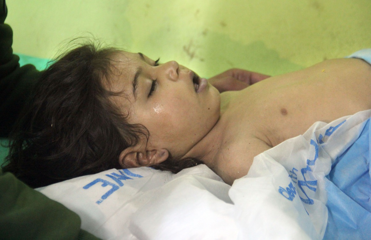 FILE PHOTO: An unconscious Syrian child receives treatment at a hospital in Khan Sheikhun, a rebel-held town in the northwestern Syrian Idlib province following a suspected toxic gas attack on April 4, 2017 (AFP / Omar haj)  