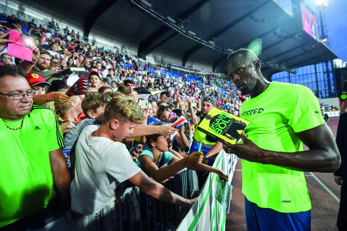 Usain Bolt of Jamaica signs  an autograph for a fan after winning the men's 100 metres event at IAAF World challenge Zlata Tretra (Golden Spike) in Ostrava, Czech Republic on Wednesday.