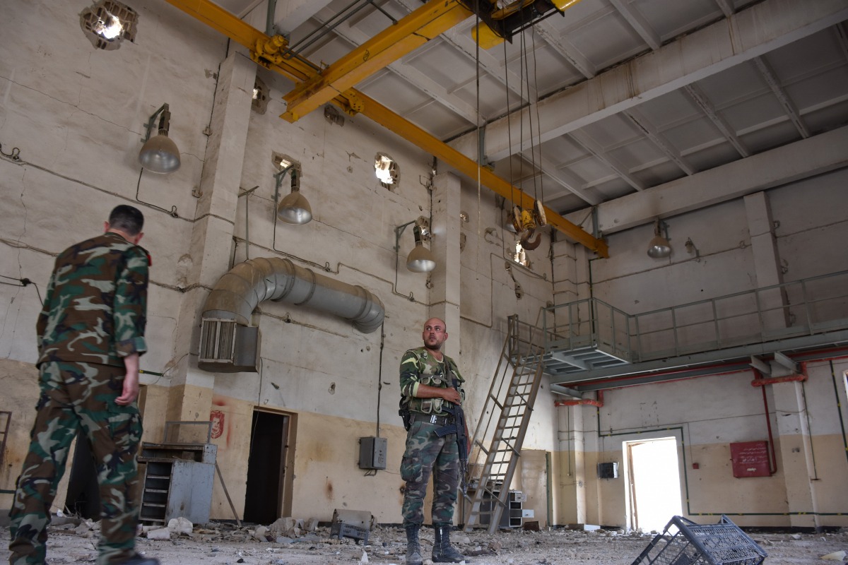 Syrian regime forces inspect an area recently recaptured from the Islamic State in a mountain range near the village of Khanasser, in the Aleppo governorate, on July 2, 2017. AFP / George Ourfalian