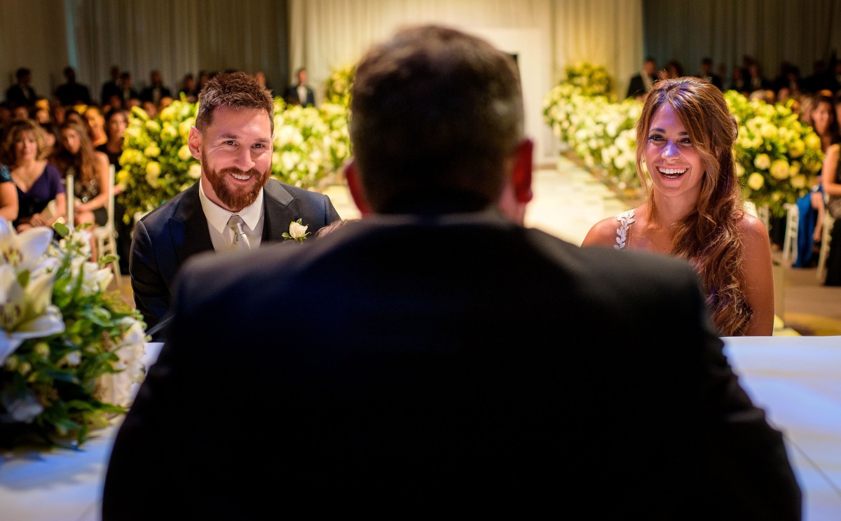 Handout picture released by WWW.MESSI.COM showing Argentine football star Lionel Messi and his bride Antonella Roccuzzo gesturing during the civil marriege ceremony at their wedding in Rosario, Santa Fe province, Argentina on June 30, 2017.