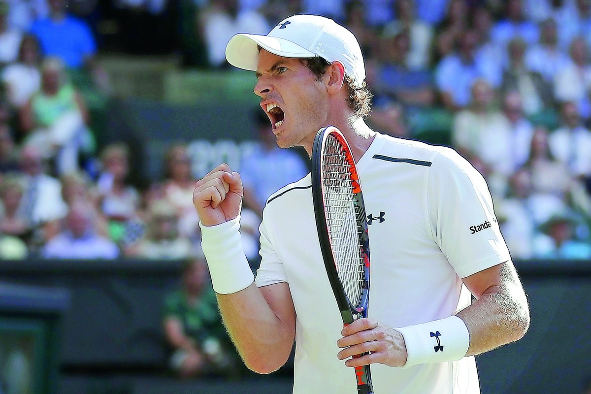 Britain's Andy Murray reacts after breaking Germany's Dustin Brown's serve during their men's singles second round match on the third day of the 2017 Wimbledon Championships at The All England Lawn Tennis Club in Wimbledon, yesterday. 