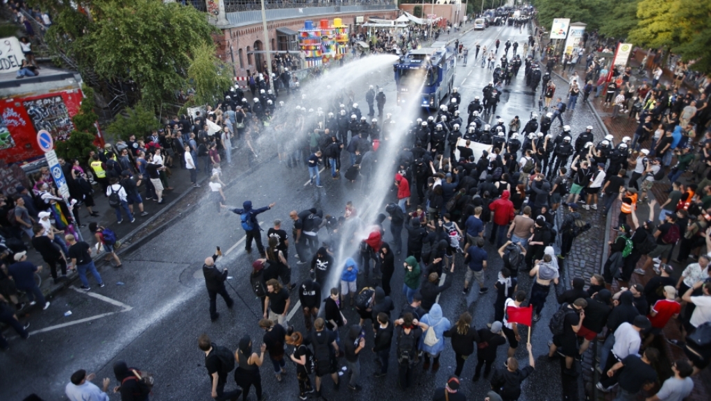 German riot police use water cannons against protesters during the demonstrations during the G20 summit in Hamburg, Germany, July 6, 2017. Credit: Fabrizio Bensch/Reuters.
