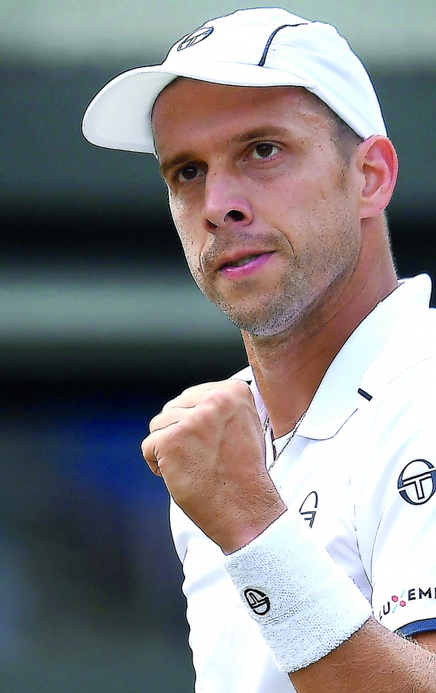 Luxembourg's Gilles Muller celebrates after scoring against Spain's Rafael Nadal during their men's singles fourth round match of the 2017 Wimbledon Championships in London yesterday. Muller won 6-3, 6-4, 3-6, 4-6, 15-13.