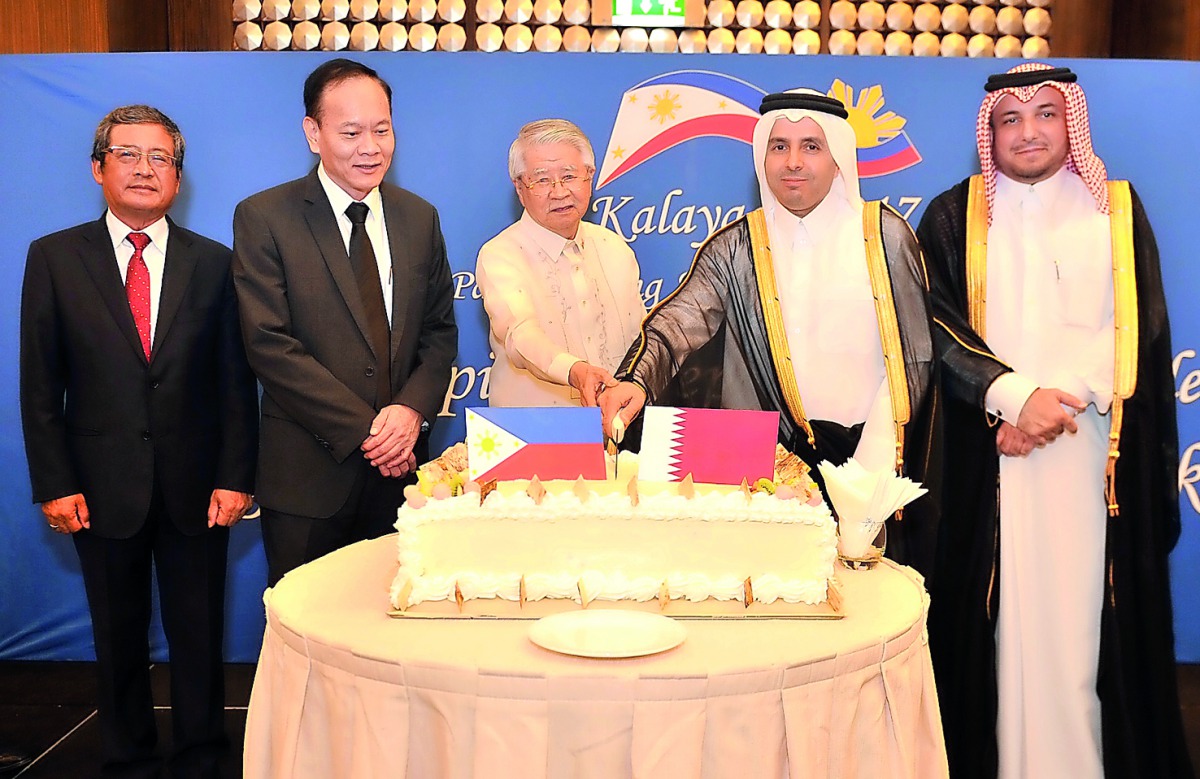 H E Dr Mohammed bin Abdul Wahed Al Hammadi, Minister of Education and Higher Education; Ibrahim Fakhroo, Director of Protocol; and Alan Timbayan (centre), Philippines Ambassador, with other officials during the Philippines National Day celebrations. Pic: 