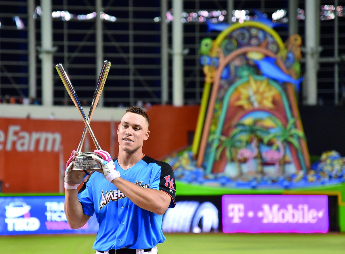 American League outfielder Aaron Judge (99) of the New York Yankees celebrates with the trophy after winning the 2017 MLB Home Run Derby at Marlins Park in Miami on Monday.