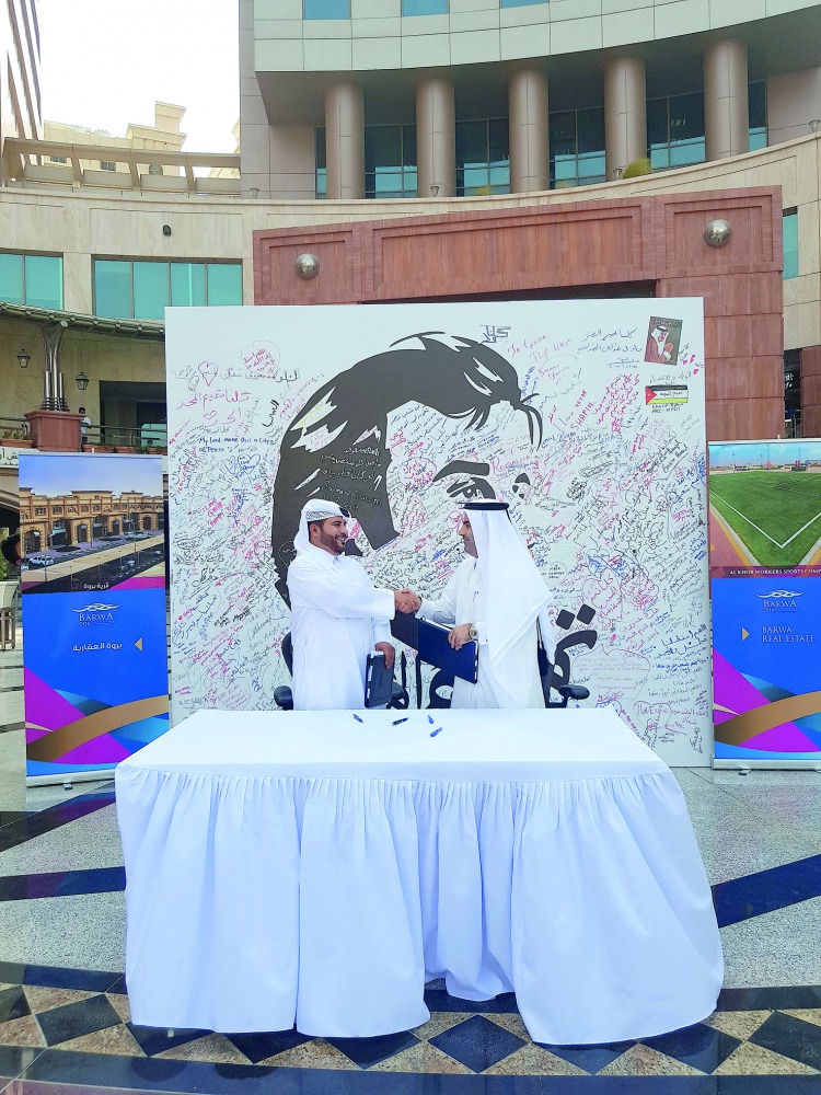 Salman bin Mohammed Al Mohannadi, CEO of Barwa Real Estate  Group, and Mohammed Hayil Al Omar, the CEO of the tenant Company, shaking hands after t signing the contract at Barwa headquarters, yesterday.

